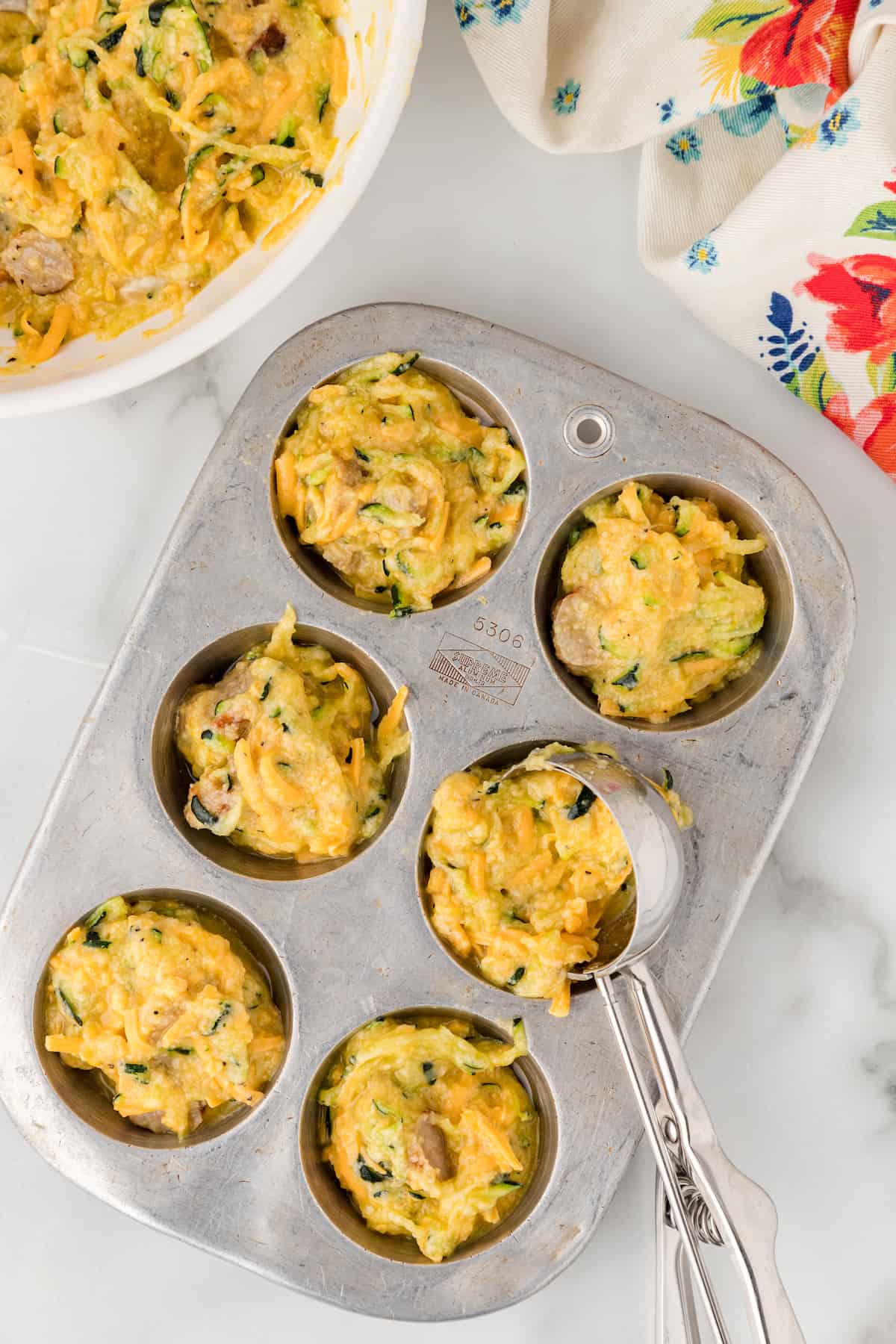 spoon the egg, zucchini, and sausage mixture into the muffin pan