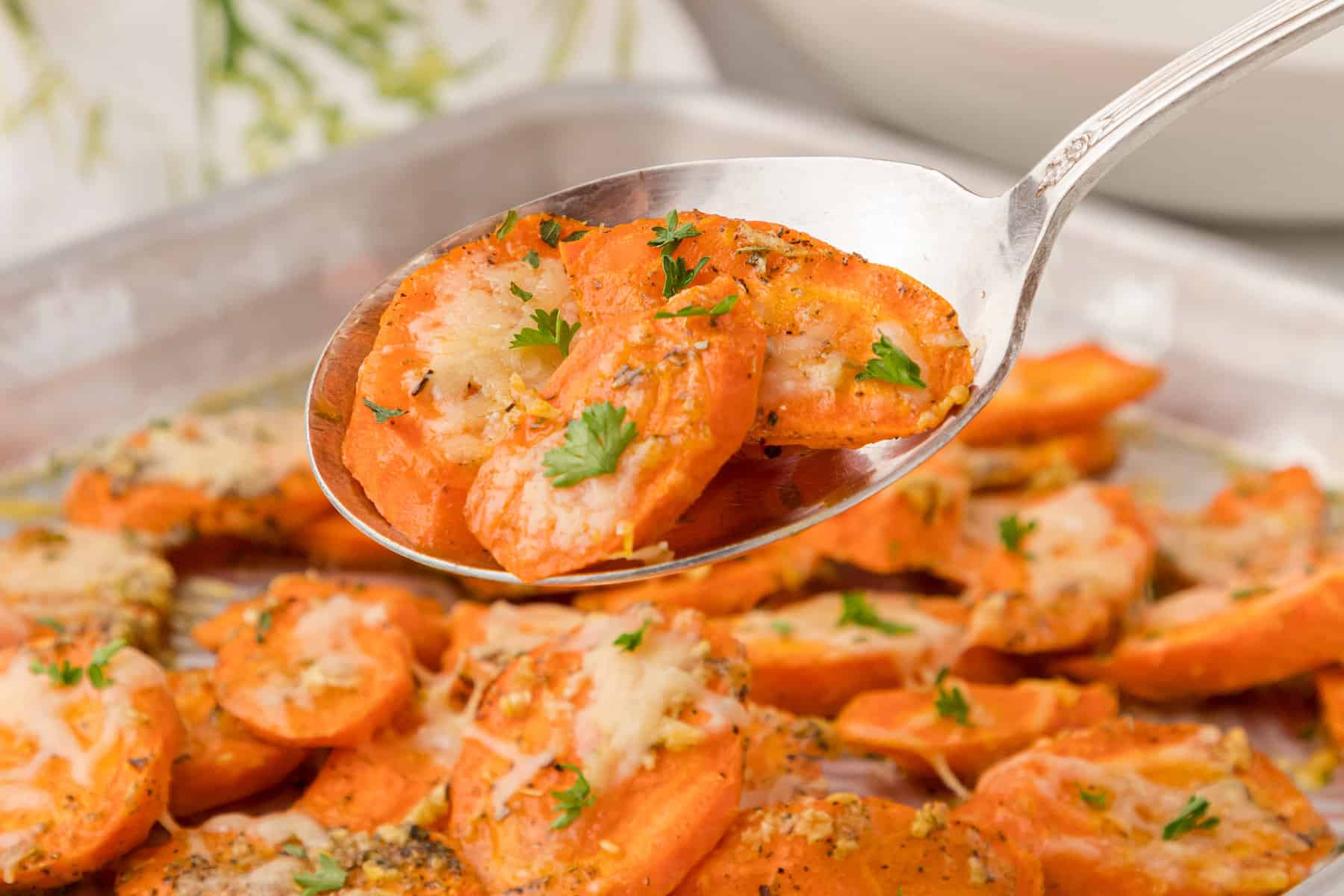 garlic parmesan roasted carrots on a silver spoon