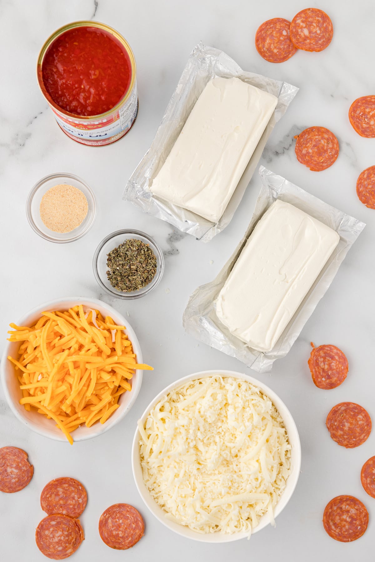 hot pepperoni dip ingredients including cream cheese, mozzarella, cheddar, spices, and pizza sauce