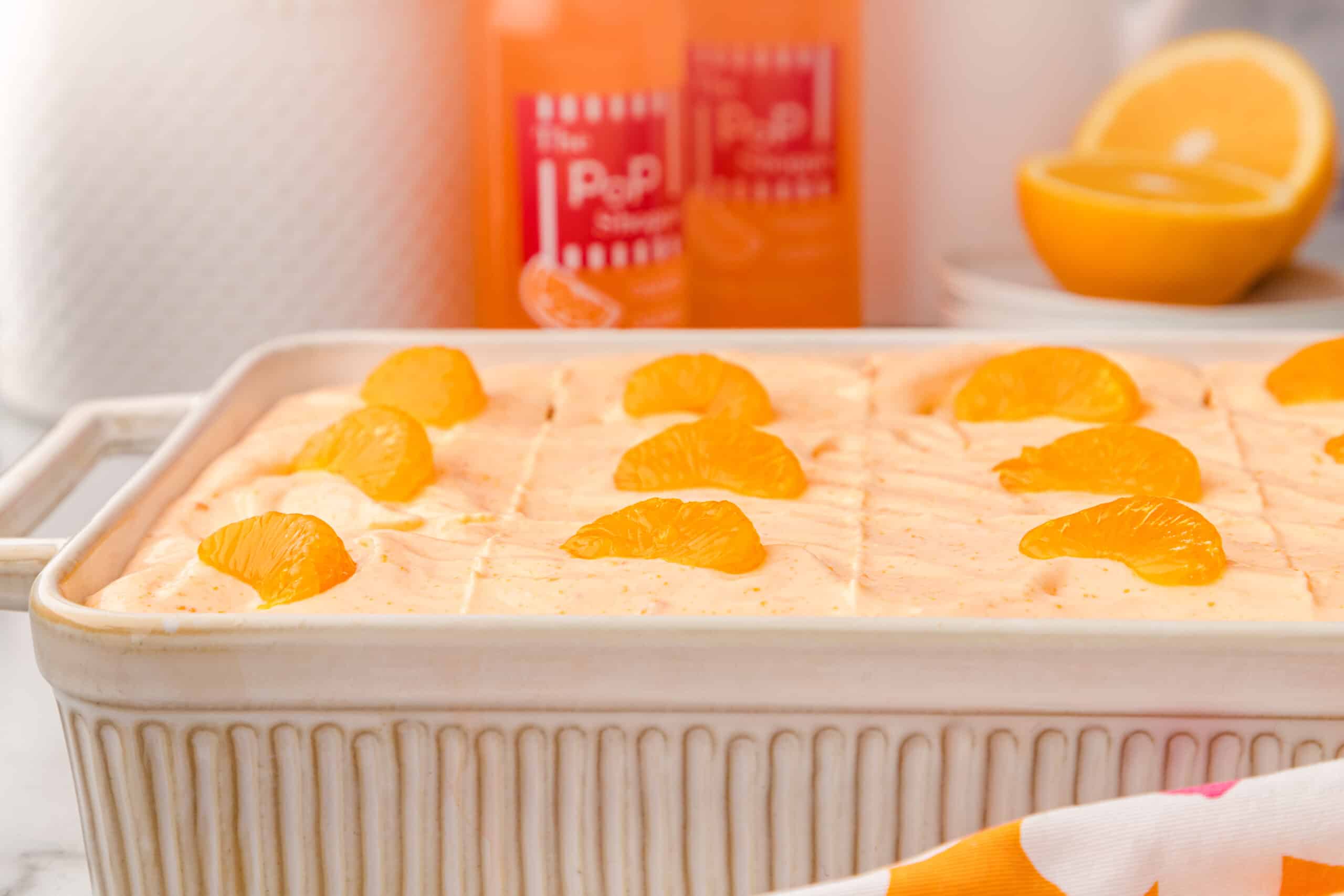 Orange Creamsicle Cake in a white cake pan