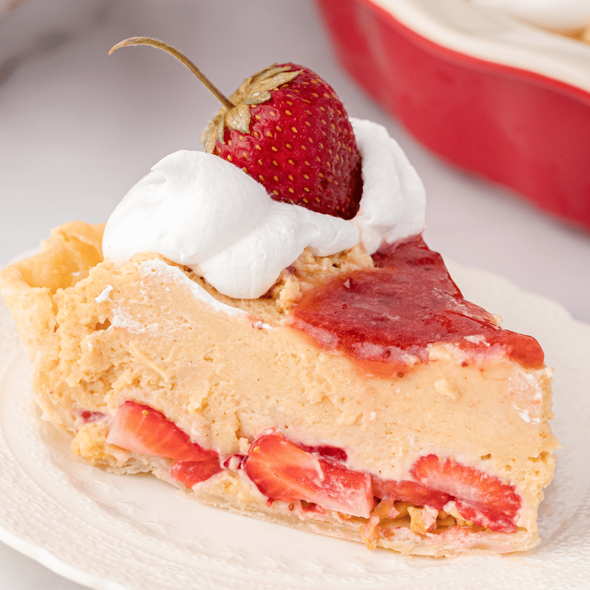 a slice of peanut butter and jelly pie with strawberries and whipped topping