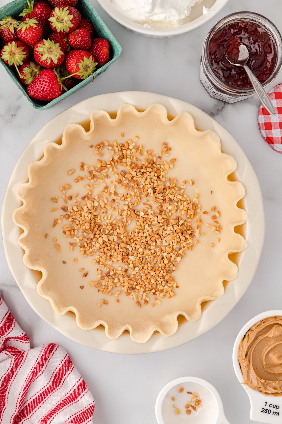 flute the edge and sprinkle the pie crust with chopped peanuts