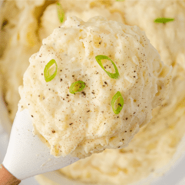 A close up of CrockPot Make Ahead Mashed Potatoes on a spatula