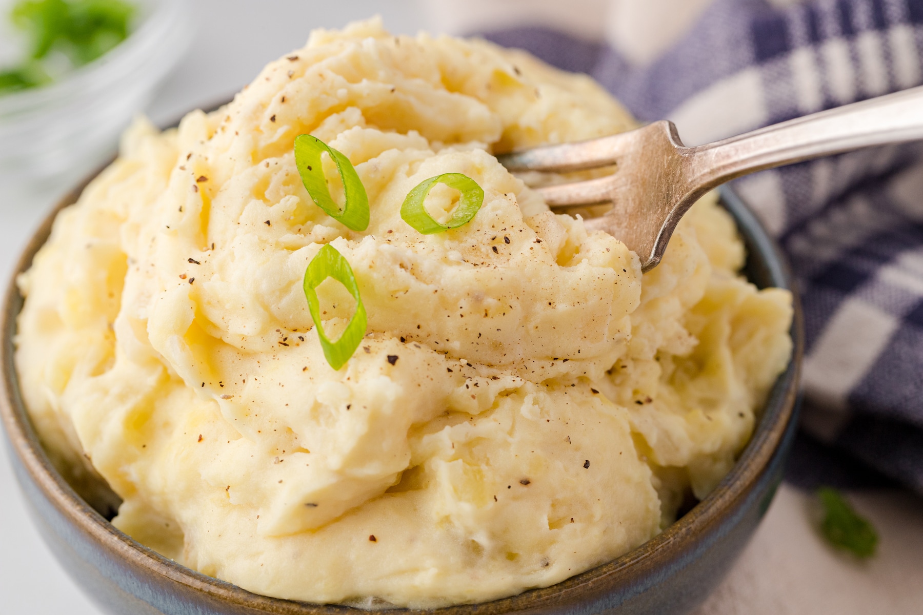 a close up of a bowl full of slow cooker mashed potatoes