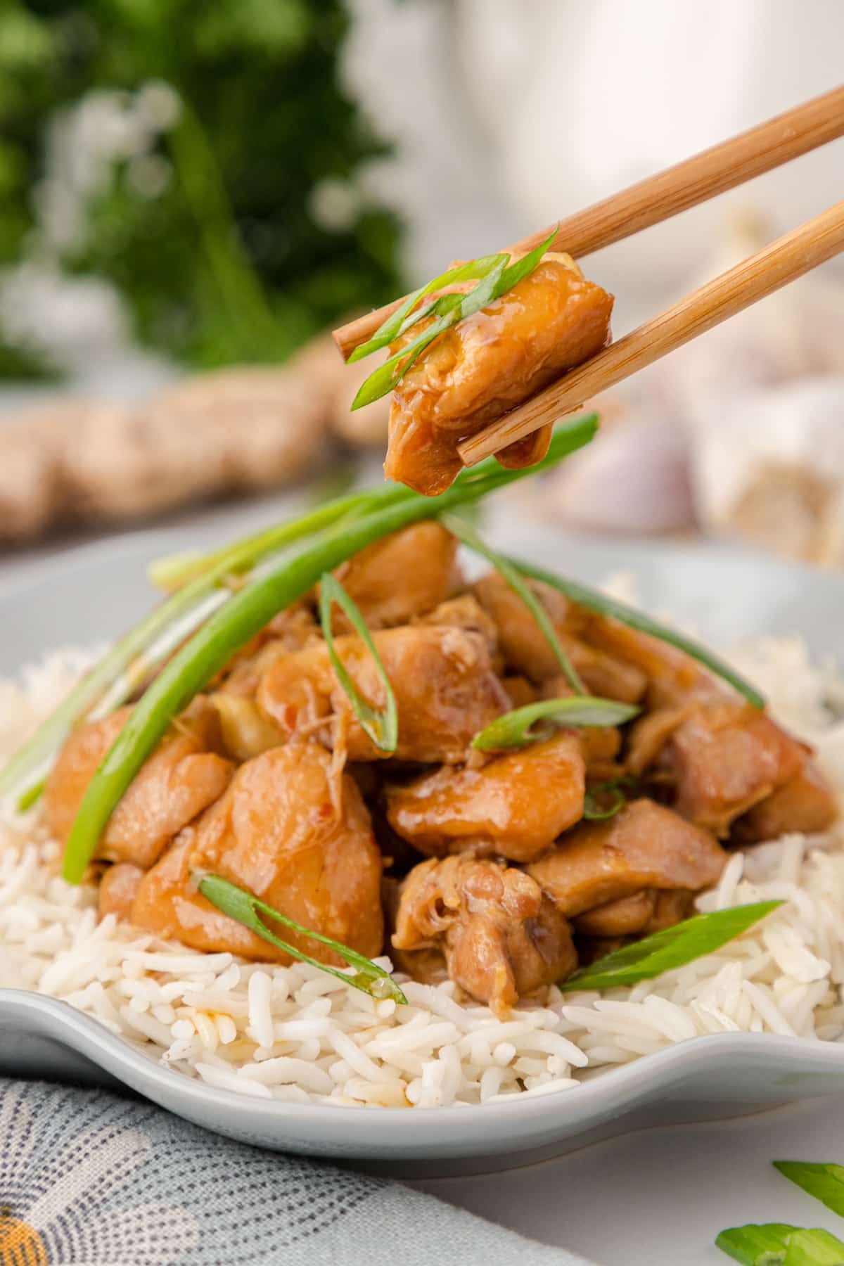 one serving of Instant Pot PF Chang's Mongolian Chicken on a bed of rice with chopsticks