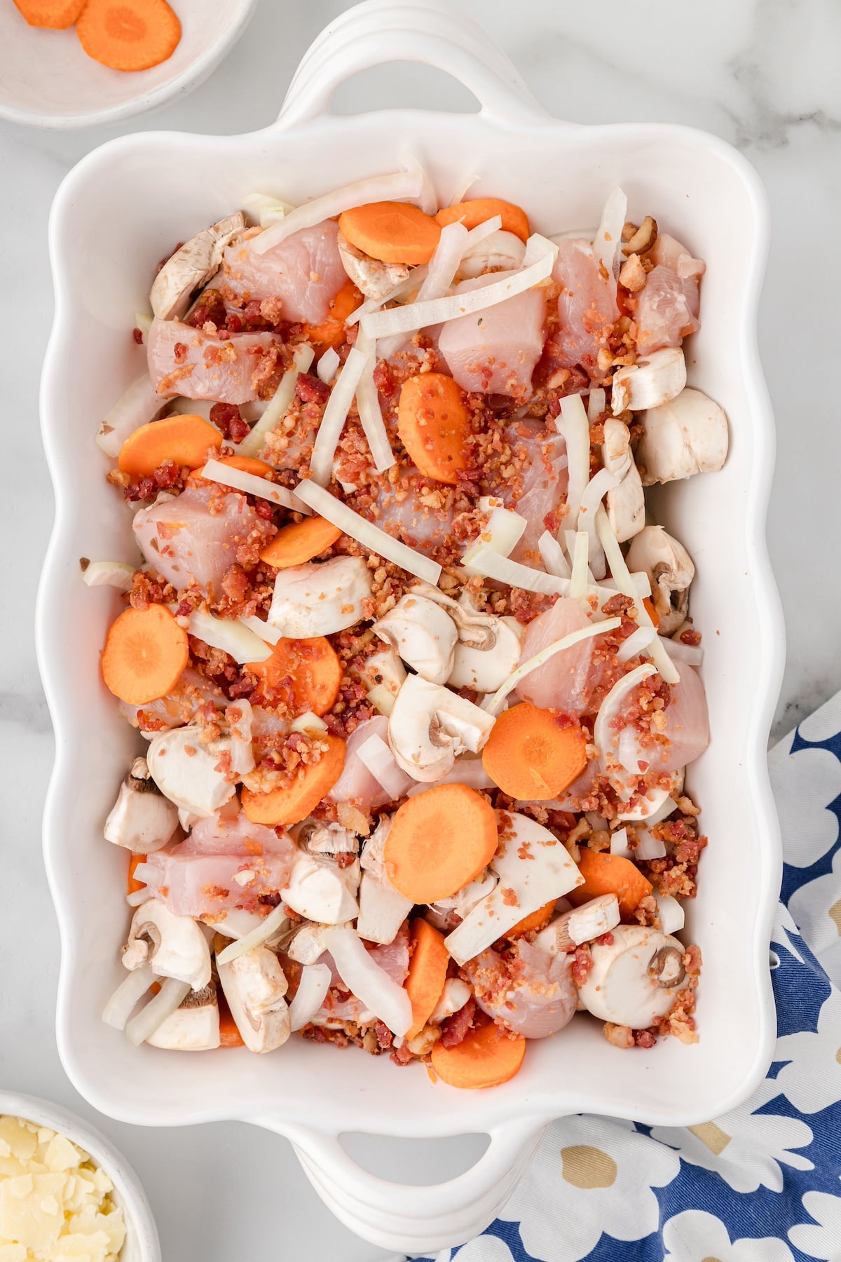 add the chicken, carrots, mushrooms, and onions to a baking dish