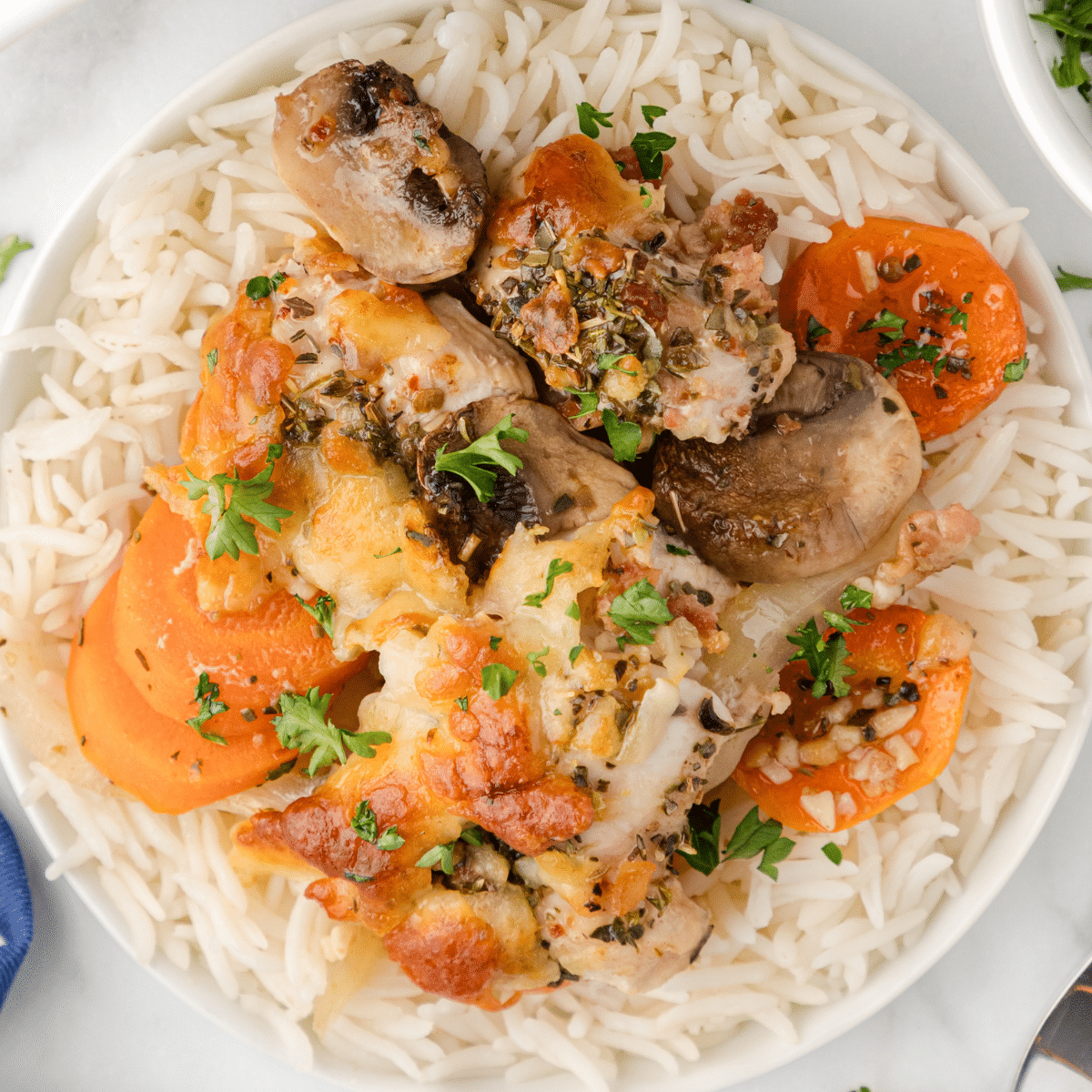 one serving of chicken savoy on a plate of rice