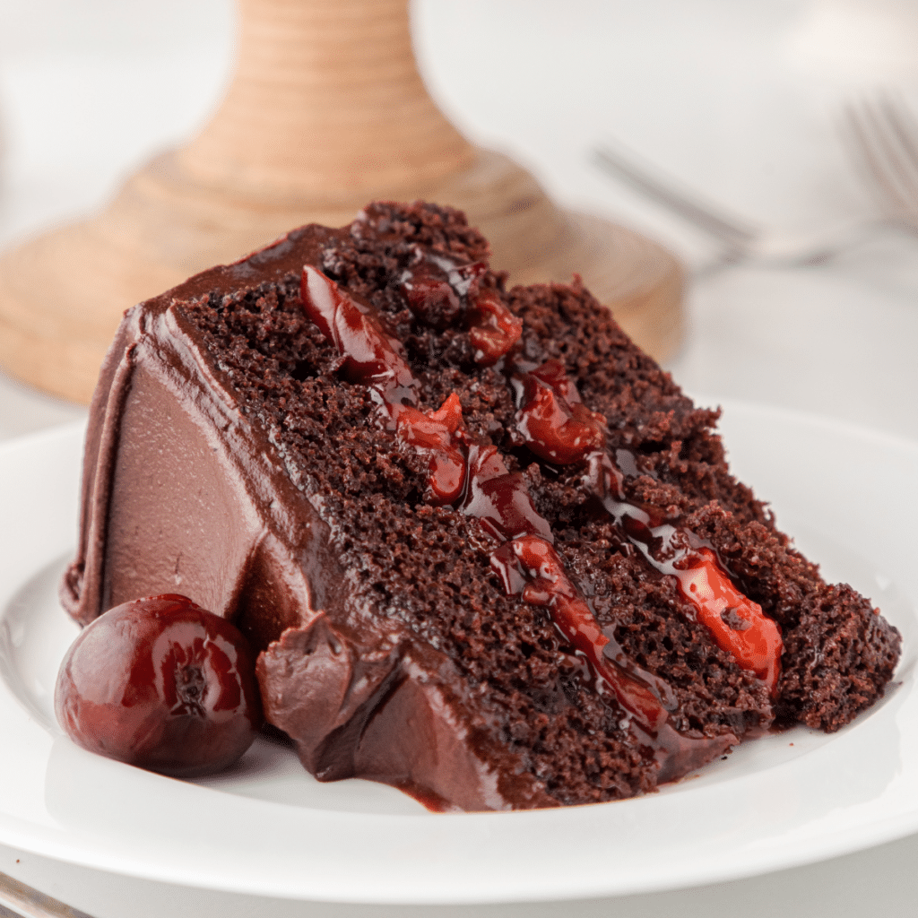 one slice of chocolate cherry cake with homemade chocolate frosting and cherry pie filling