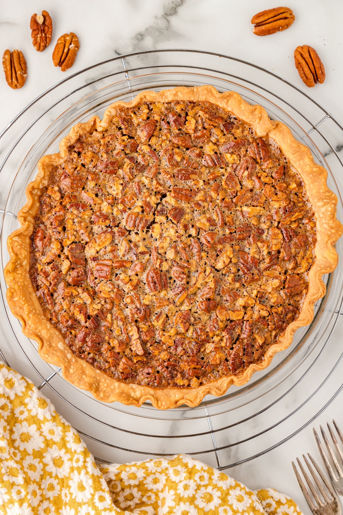 the world's best pecan pie just out of the oven on a wire cooling rack