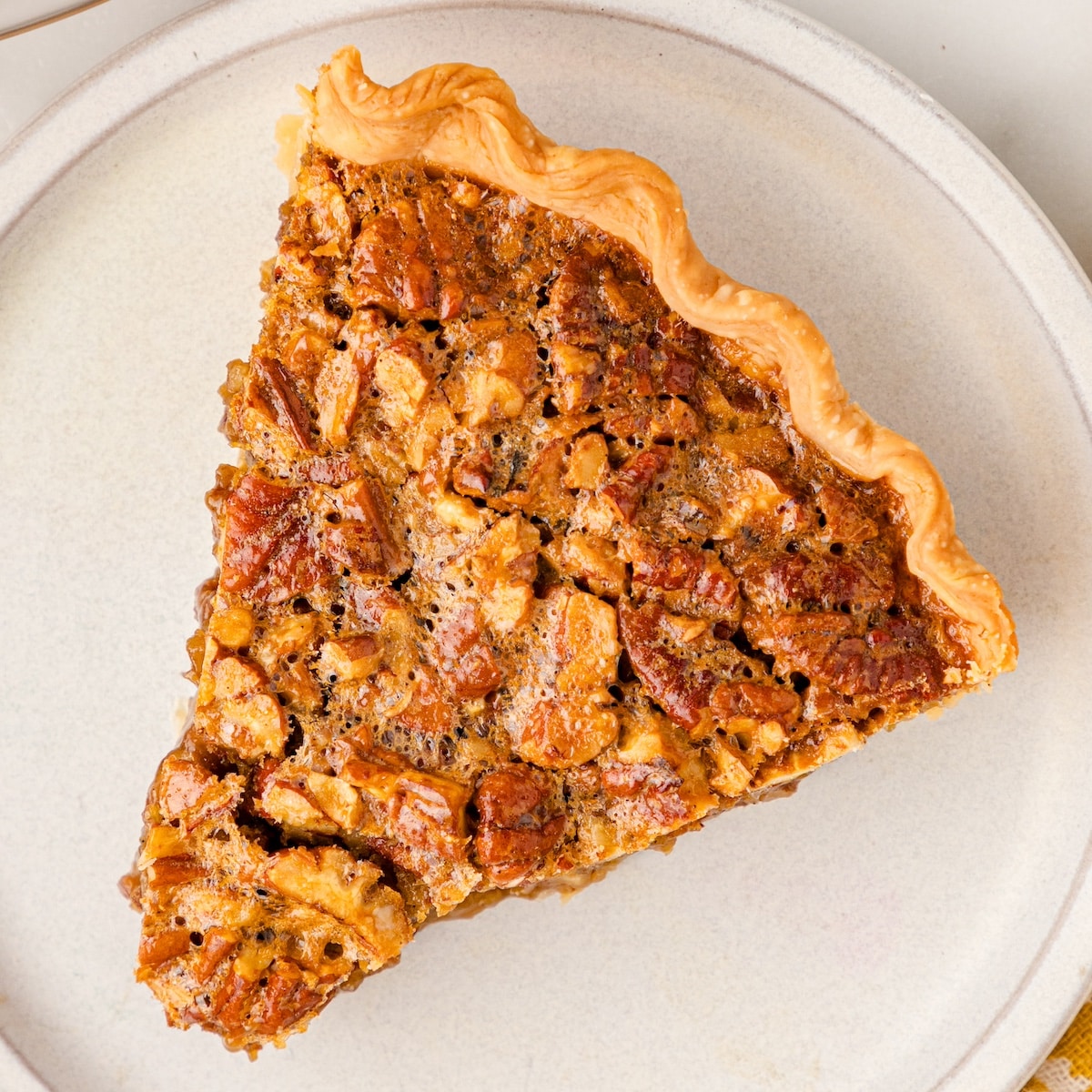 a close up of one slice of the best ever pecan pie