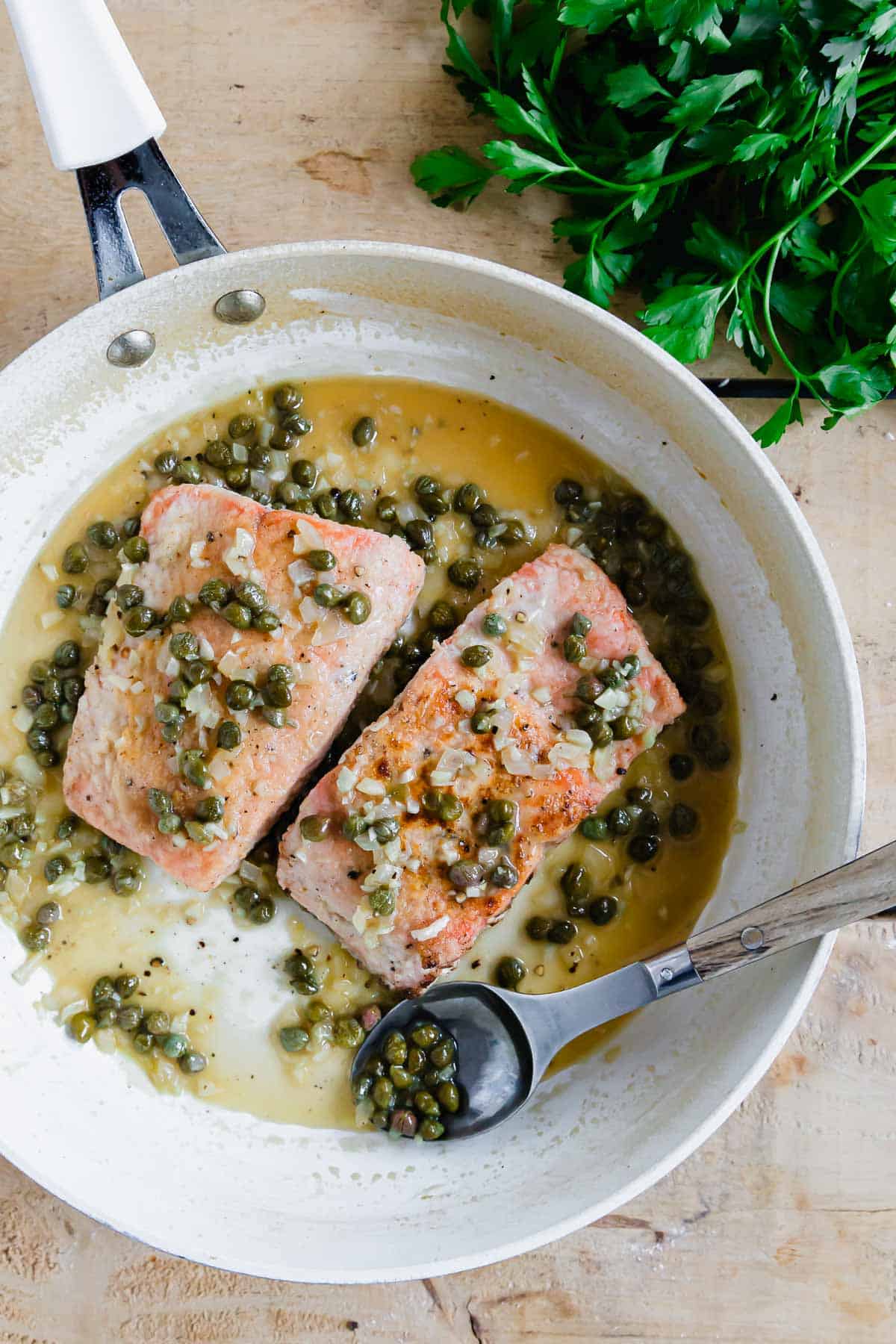 top the salmon filets with capers and shallots