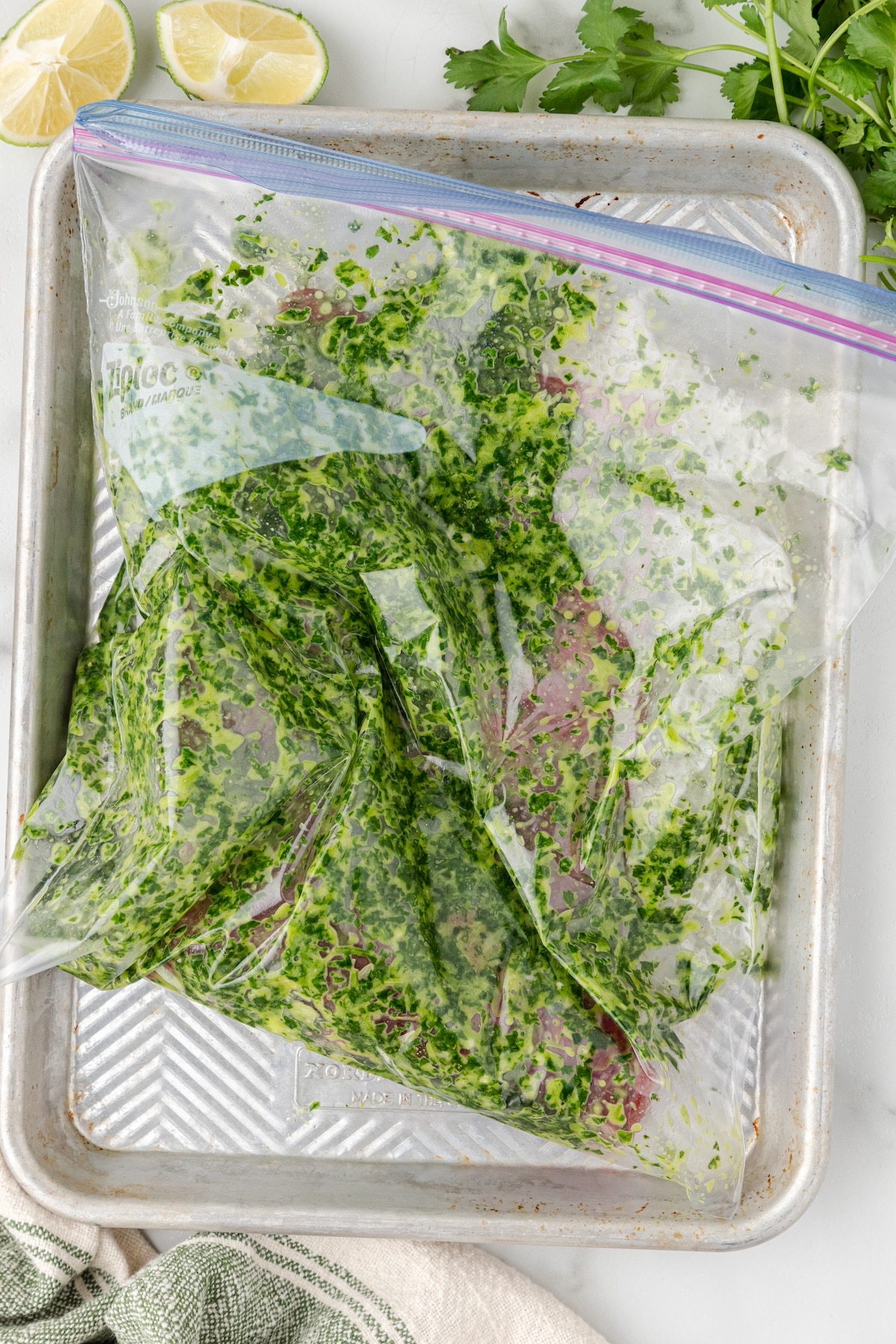a flank steak with cilantro marinade in a zippered plastic bag