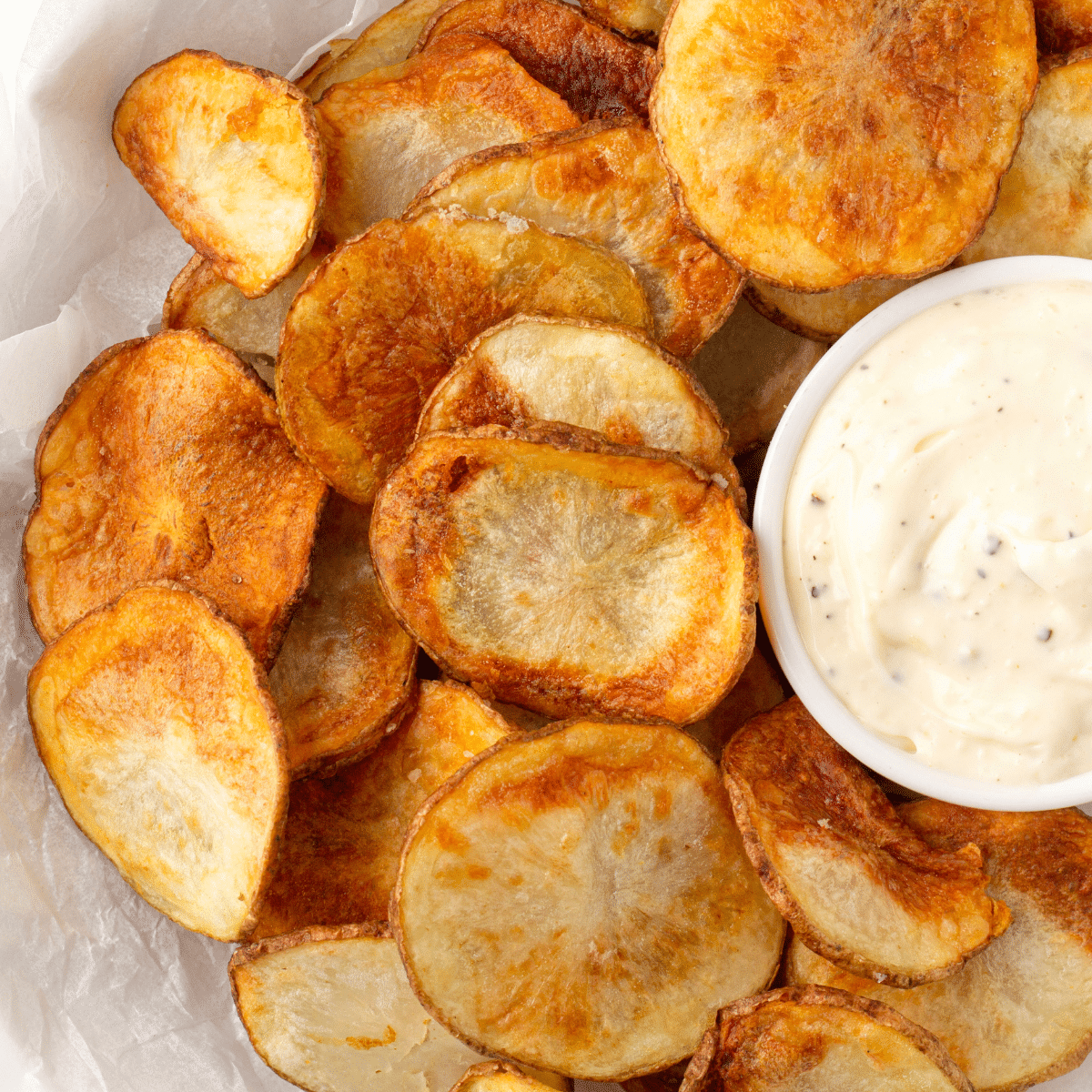 homemade air fryer potato chips with horseradish aioli in parchment paper