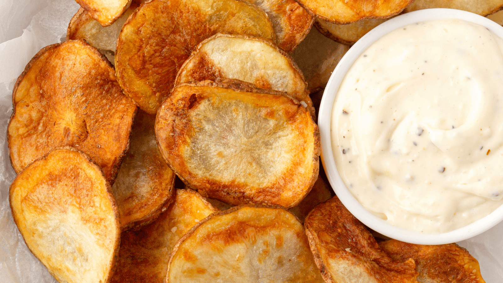 a close up of homemade air fryer potato chips with horseradish aioli