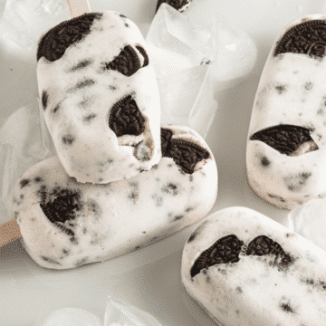 Oreo Ice Cream Popsicles with ice cubes on a white plate