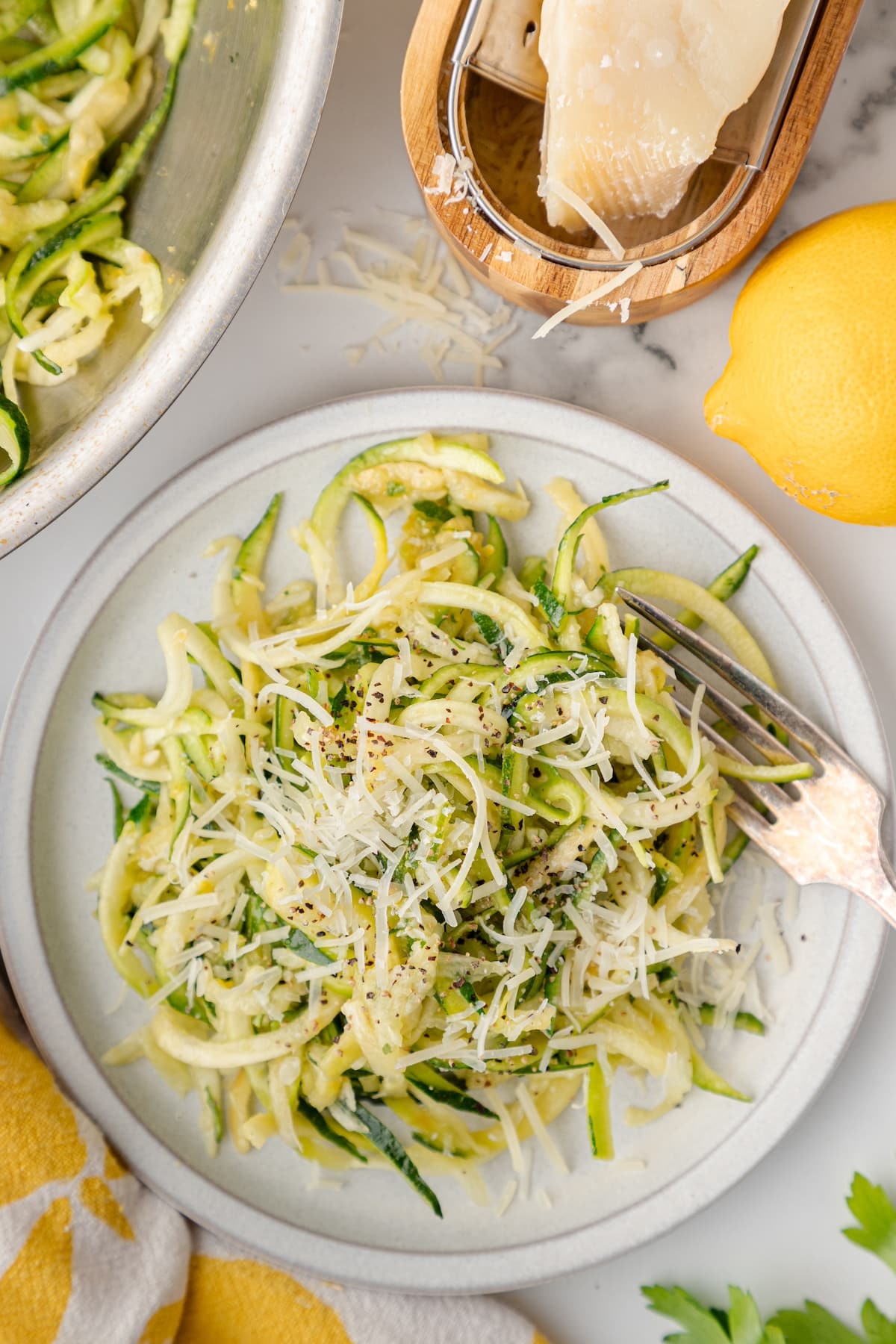one serving of lemon zucchini noodles topped with black pepper and Parmesan cheese