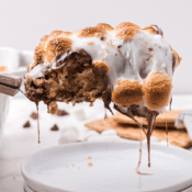 s'mores bar with chocolate and marshmallows dripping off the spatula