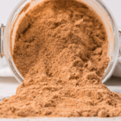 sweet and spicy homemade BBQ seasoning spilled out of a jar on the counter