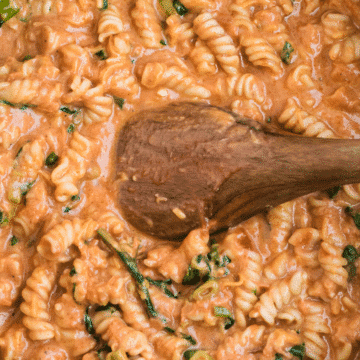 Pasta with Tomato Gorgonzola Sauce and a wooden spoon