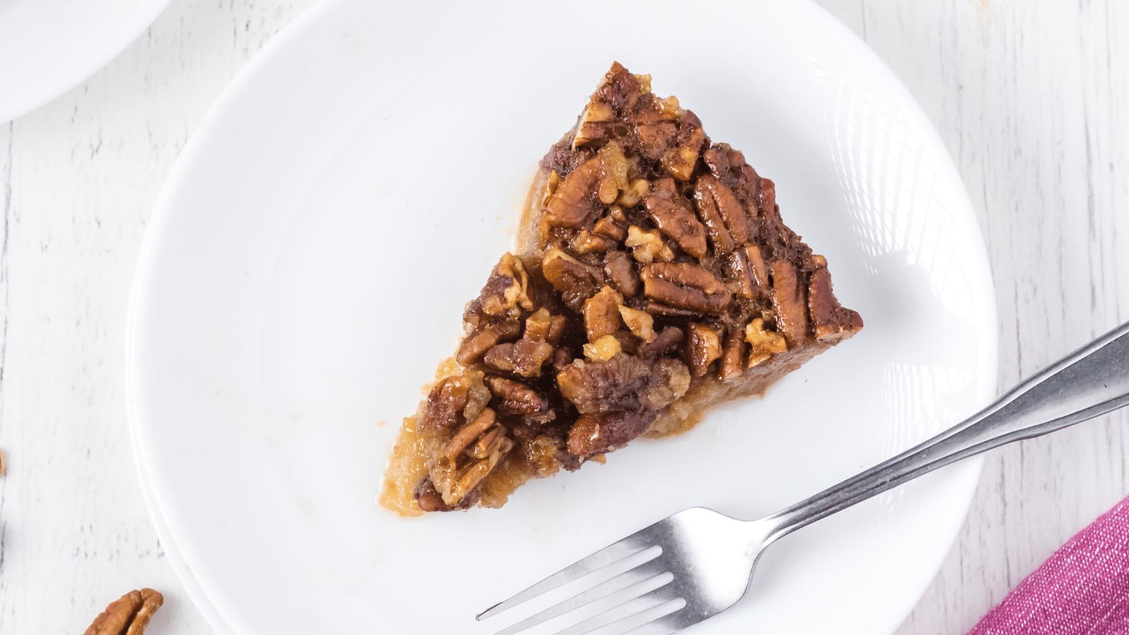 one slice of crustless gluten-free pecan pie from above on a white plate with a fork