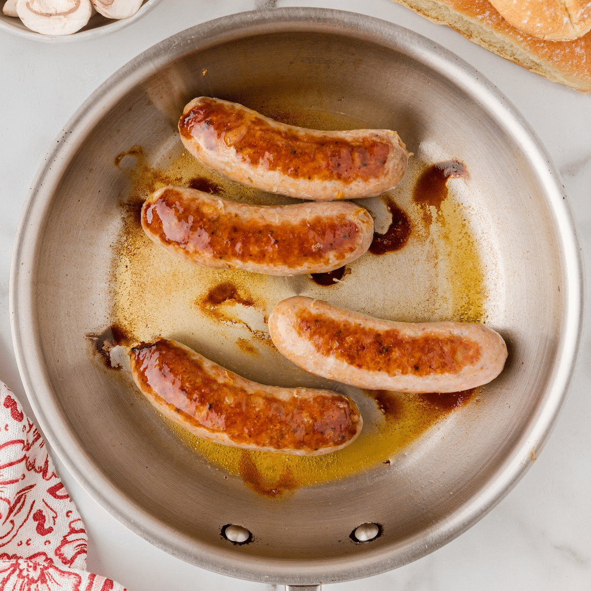 bratwurst cooking in a skillet