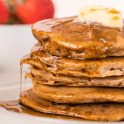 a stack of sweet potato pancakes topped with butter and syrup