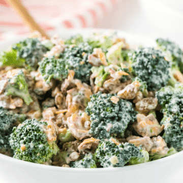a close up of the best broccoli salad in a white bowl