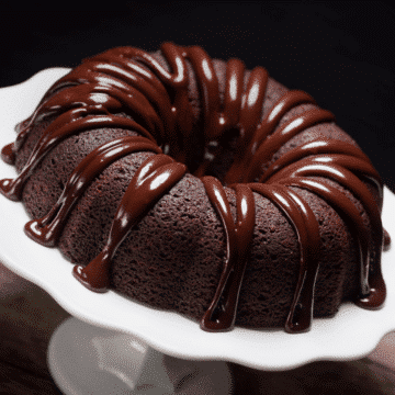triple chocolate bundt cake on a white cake plate