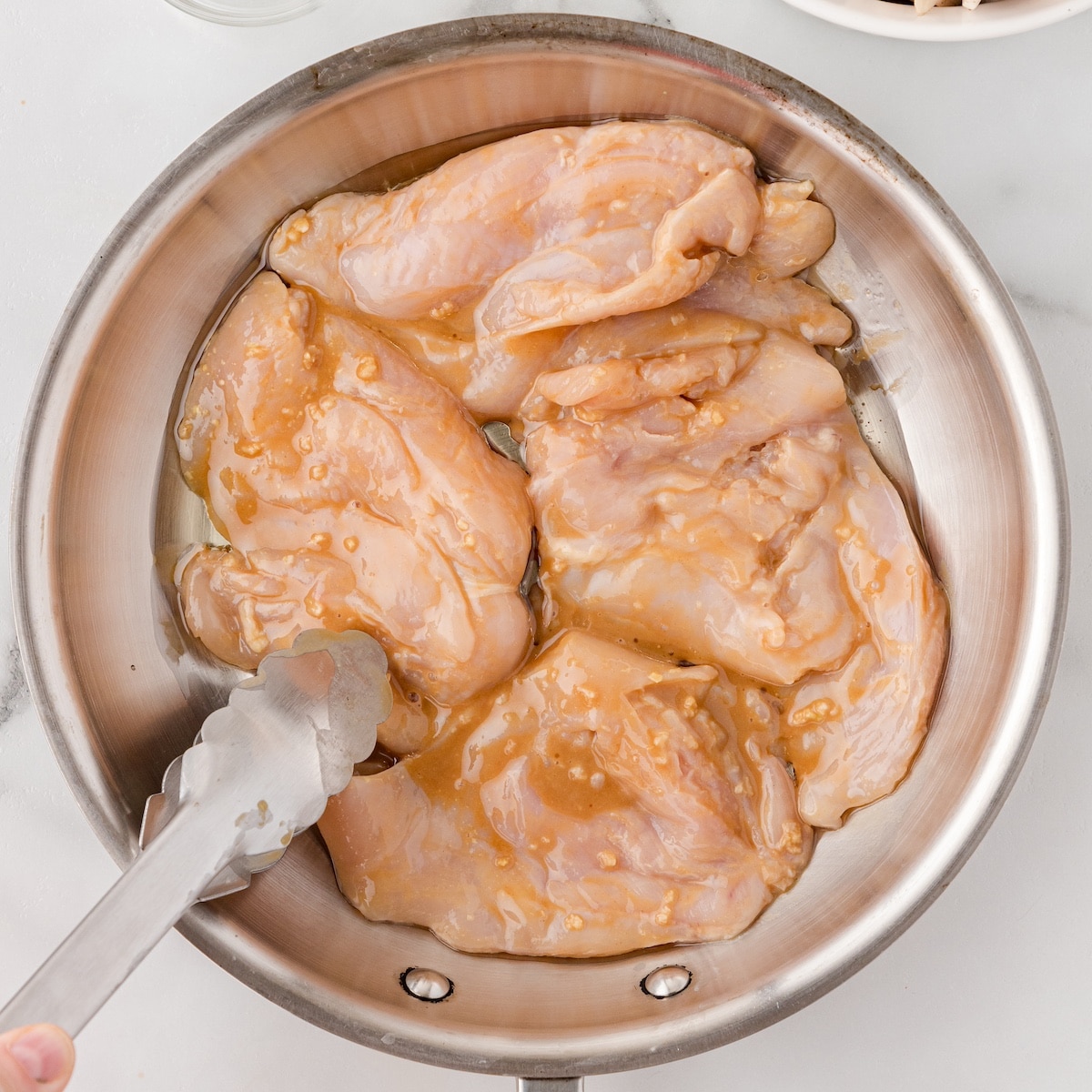 turn the chicken breasts to coat them in the balsamic marinade