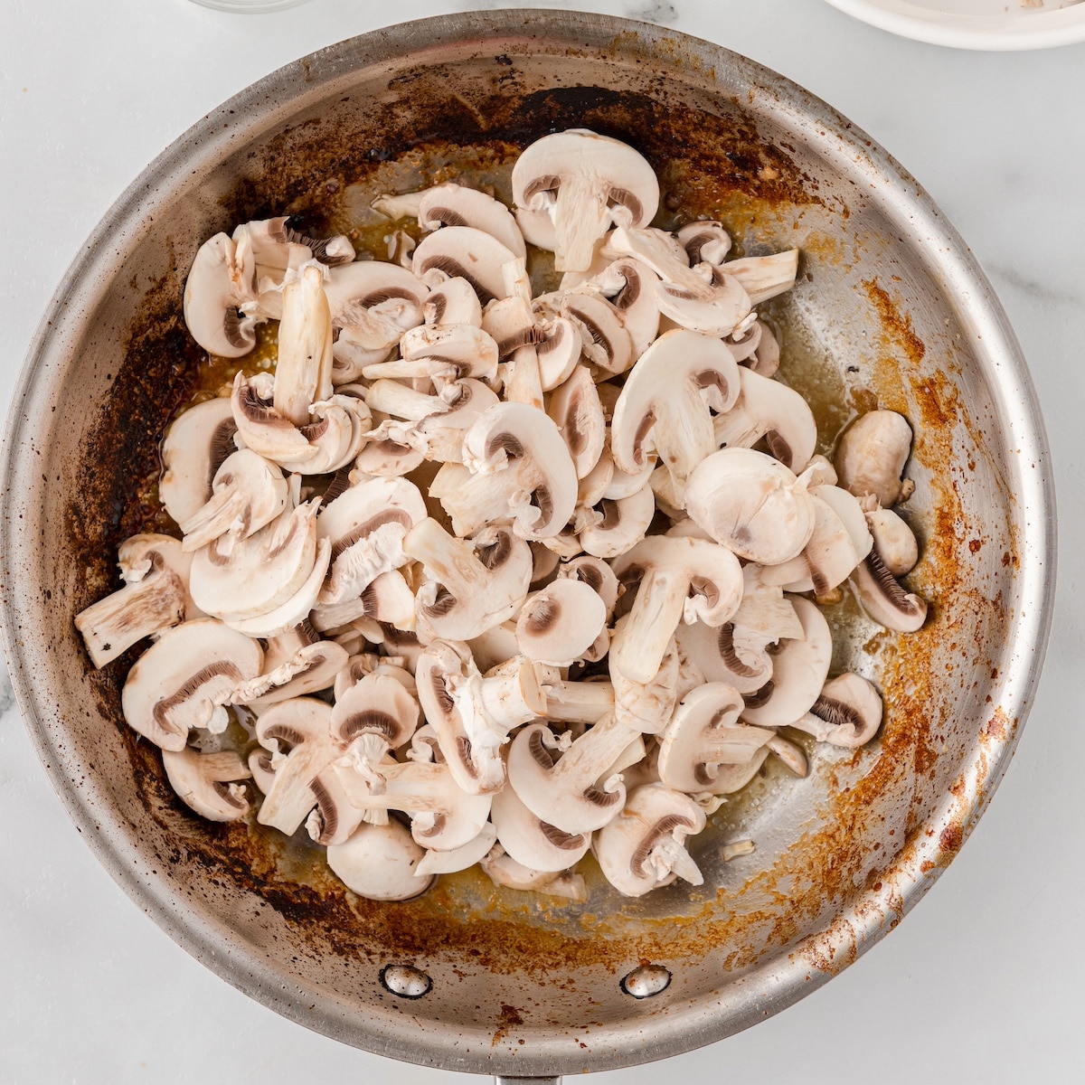 add the mushrooms and onions to the hot skillet