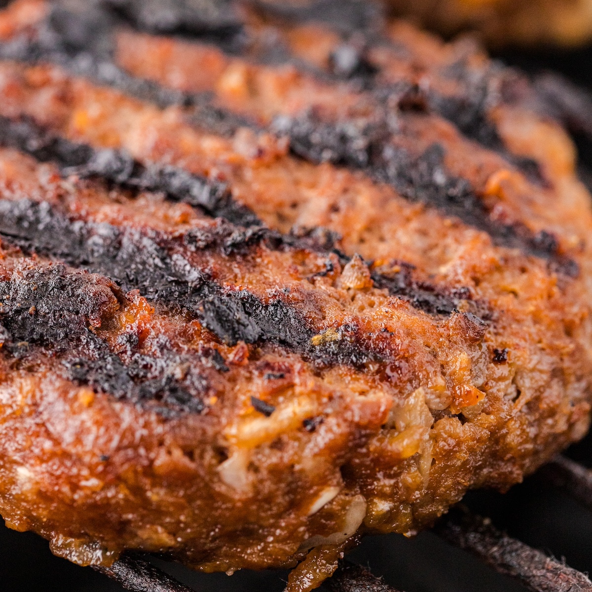 an extreme close up of the best grilled BBQ burgers on the grill