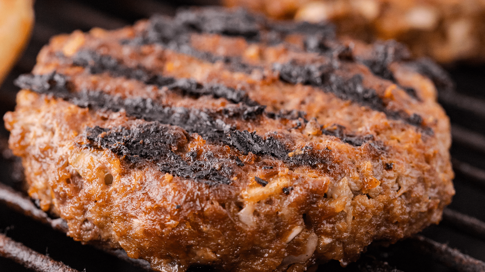 a close up of the best grilled BBQ burgers on the grill