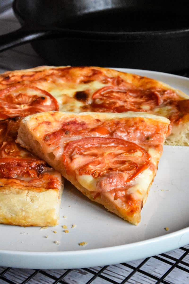 one slice of sourdough pizza crust on a white plate