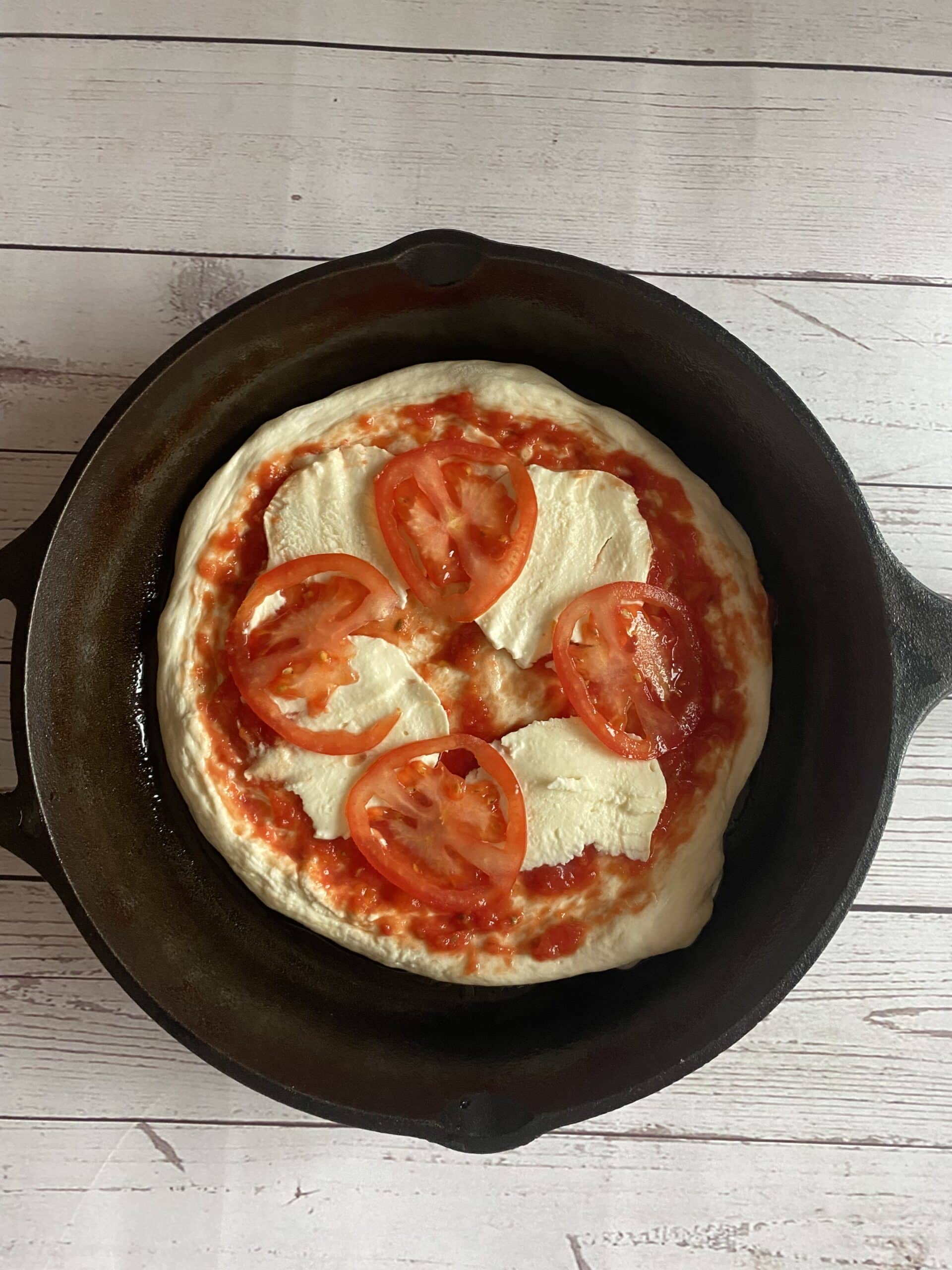 top the sourdough pizza crust with sauce and toppings