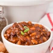 a single serving of CrockPot BBQ Baked Beans with Bacon topped with green onions