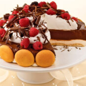 no bake chocolate mousse cheesecake pie with vanilla wafers, cream cheese, and chocolate pudding topped with chocolate shavings and red raspberries