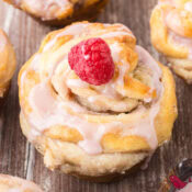raspberry cream cheese cruffin made from crescent rolls and topped with a fresh red raspberry