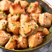a close up of Air Fryer Garlic Honey Dijon Salmon Bites topped with sesame seeds