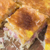 one hot ham and cheese puff pastry sandwich with swiss cheese