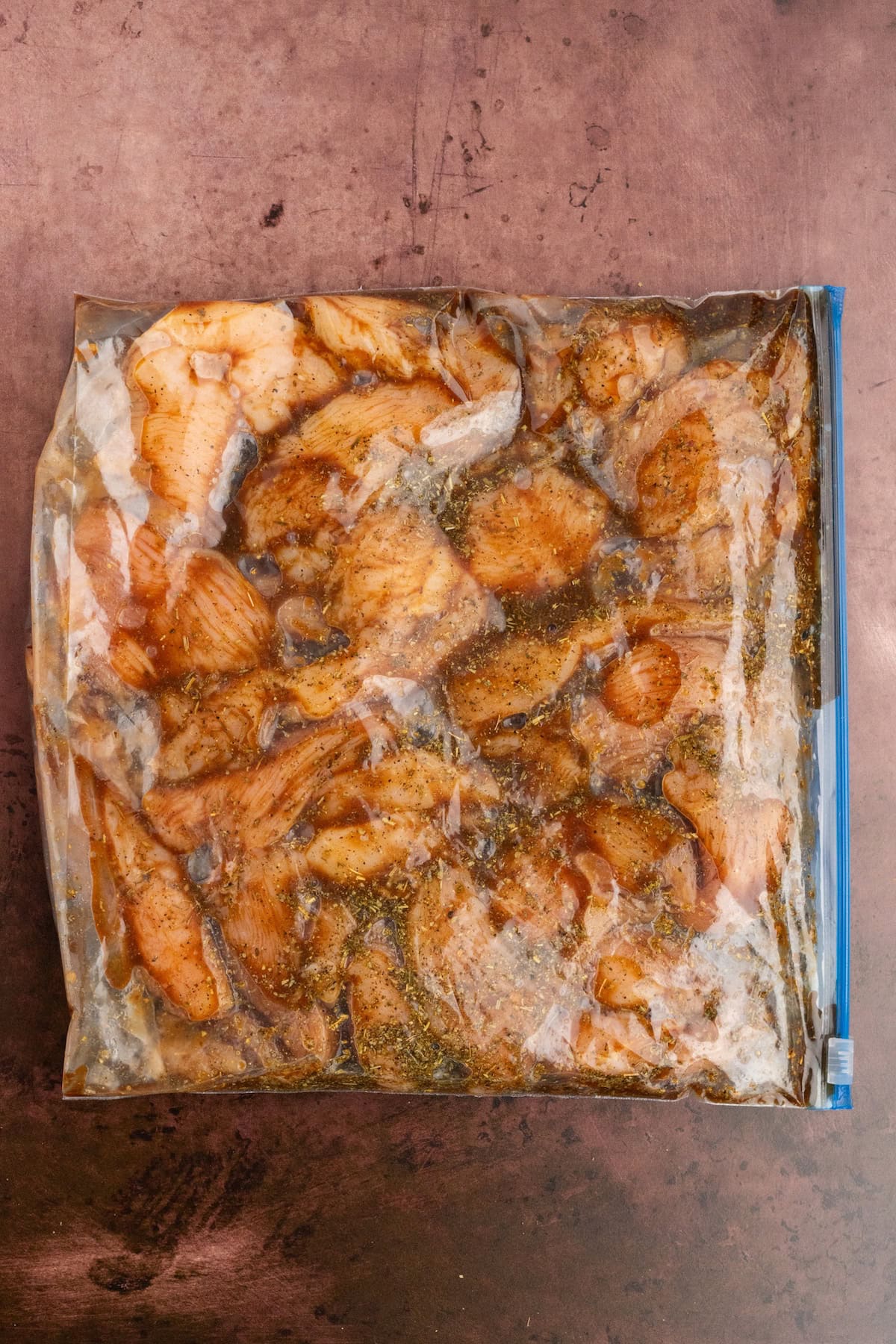 chicken soaking in a balsamic herb marinade