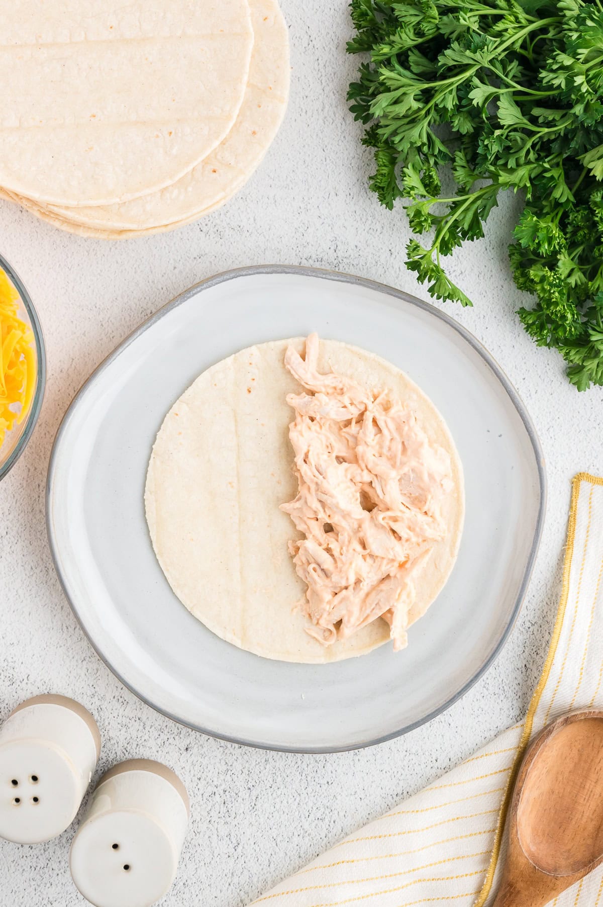 place two ounces of buffalo chicken on half of a flour or corn tortilla