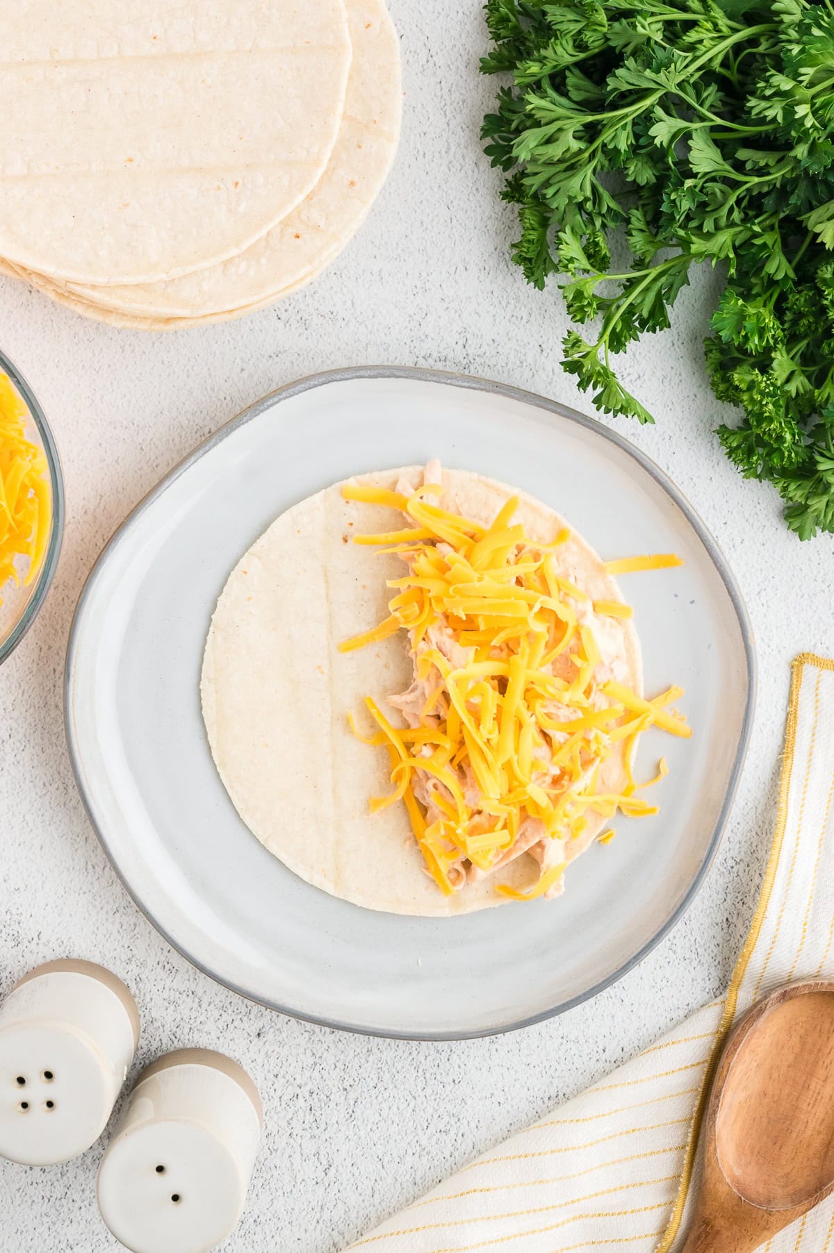 top the buffalo chicken with shredded cheddar cheese