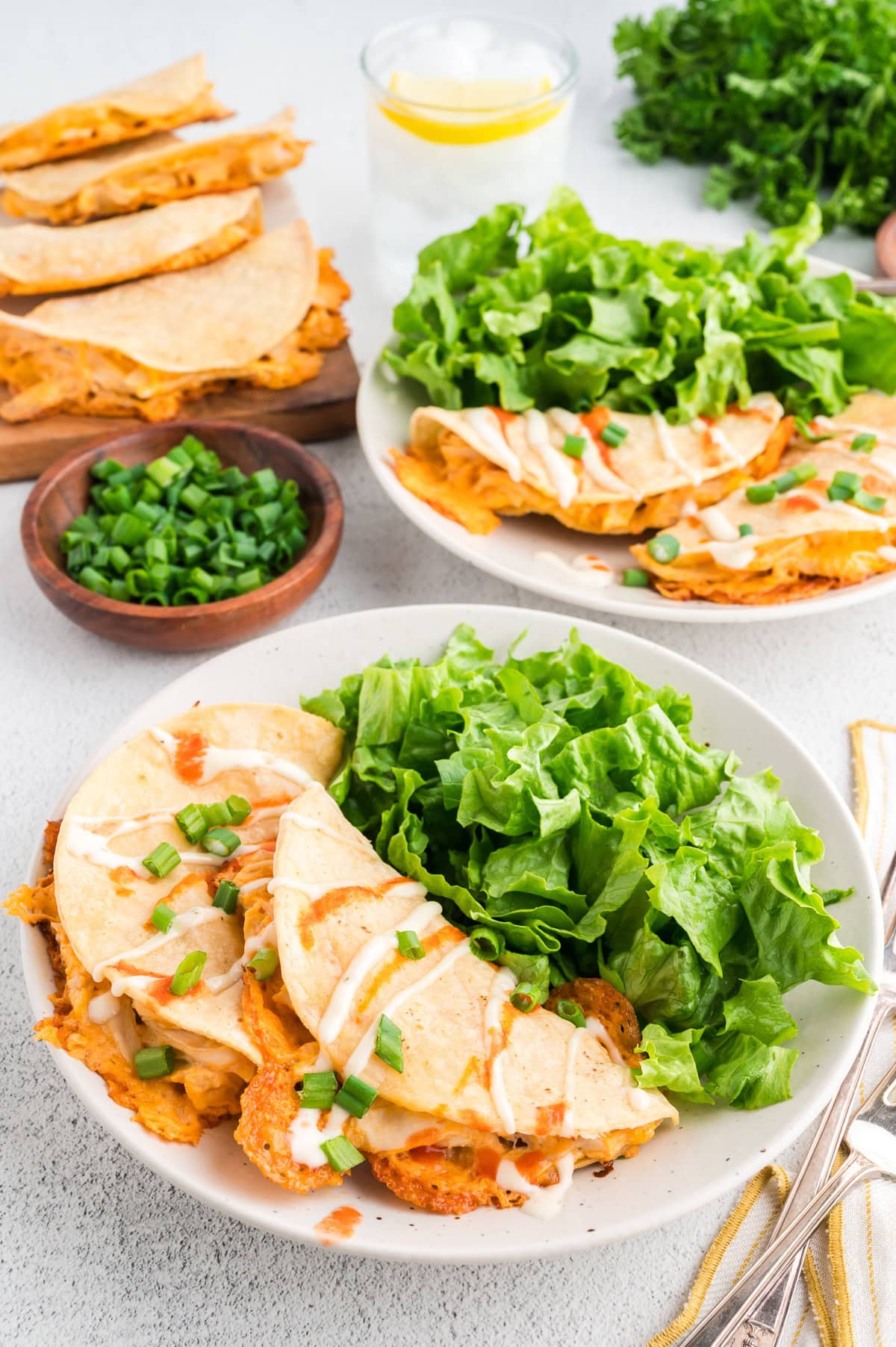 Oven baked tacos on plates with fresh greens