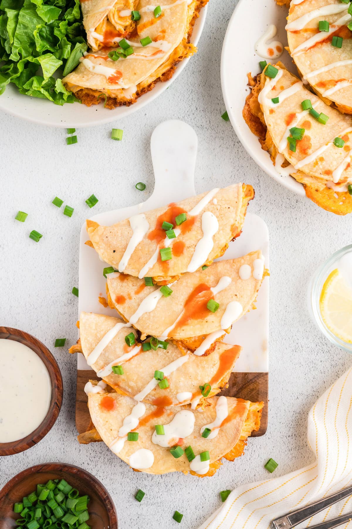 a tray of Buffalo chicken tacos drizzled with ranch dressing and Franks RedHot sauce
