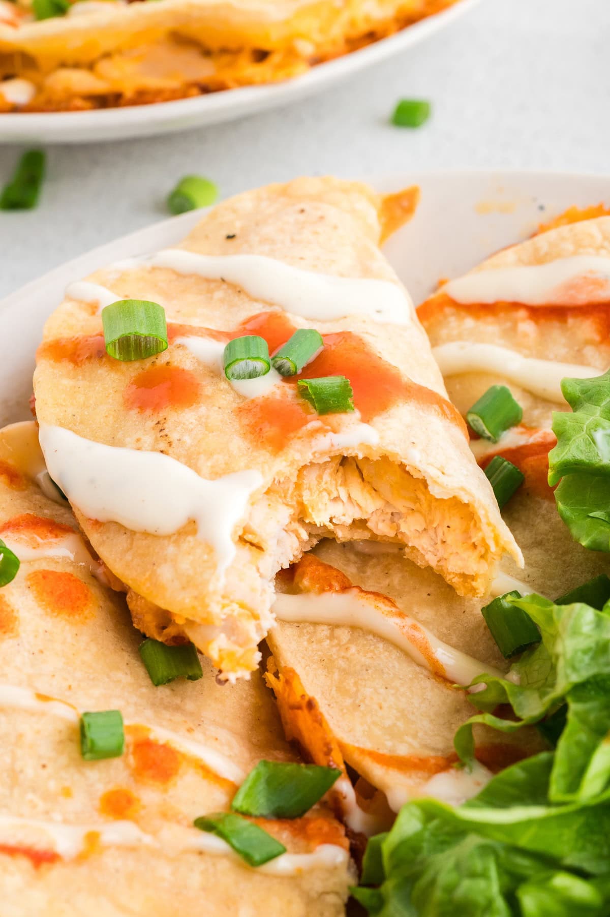 one buffalo chicken taco with a bite out