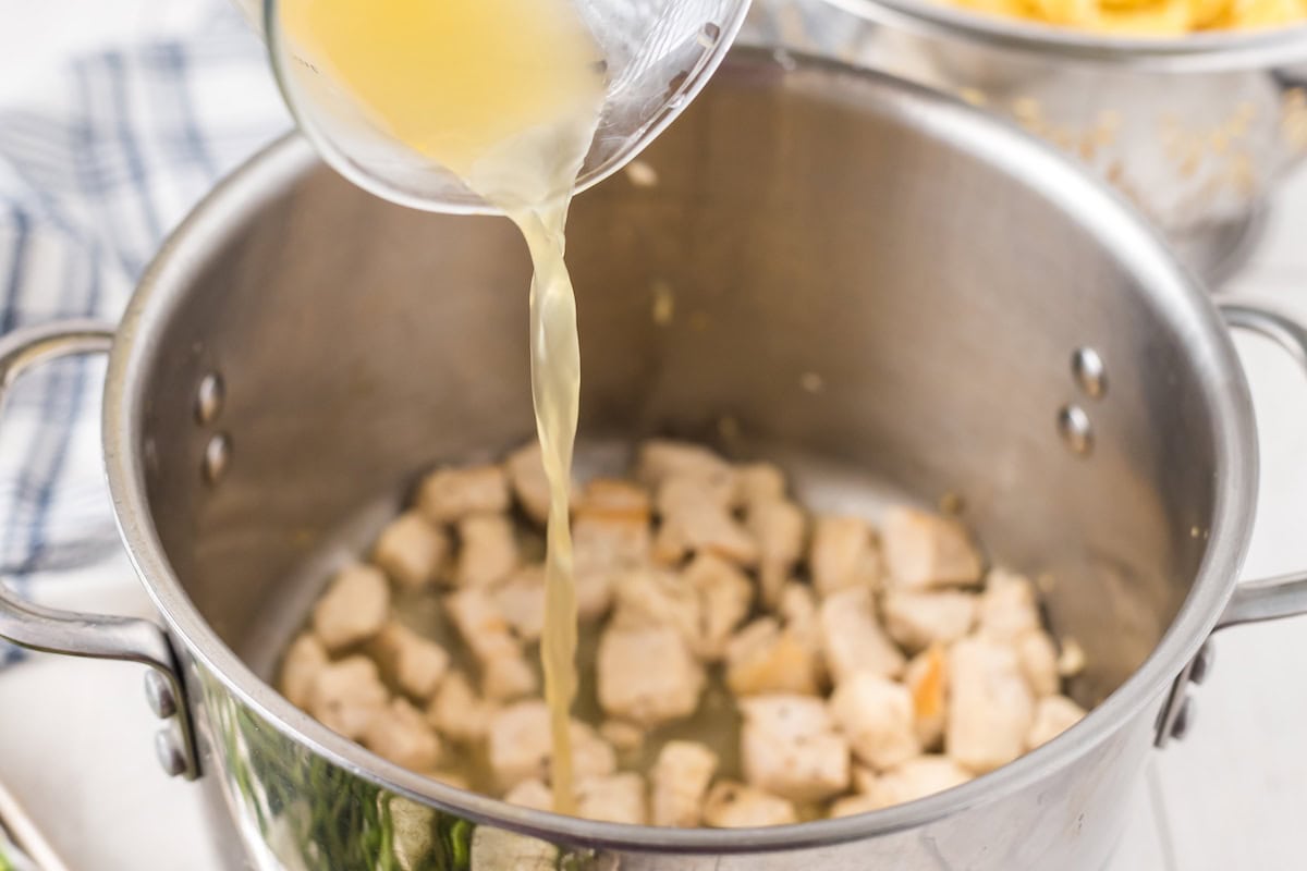 pour the chicken broth into the pot