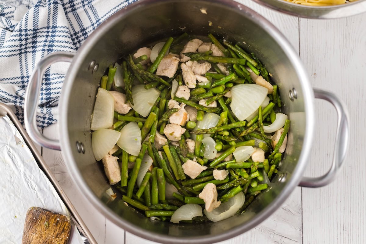 mix the asparagus and onions with the chicken in the pot