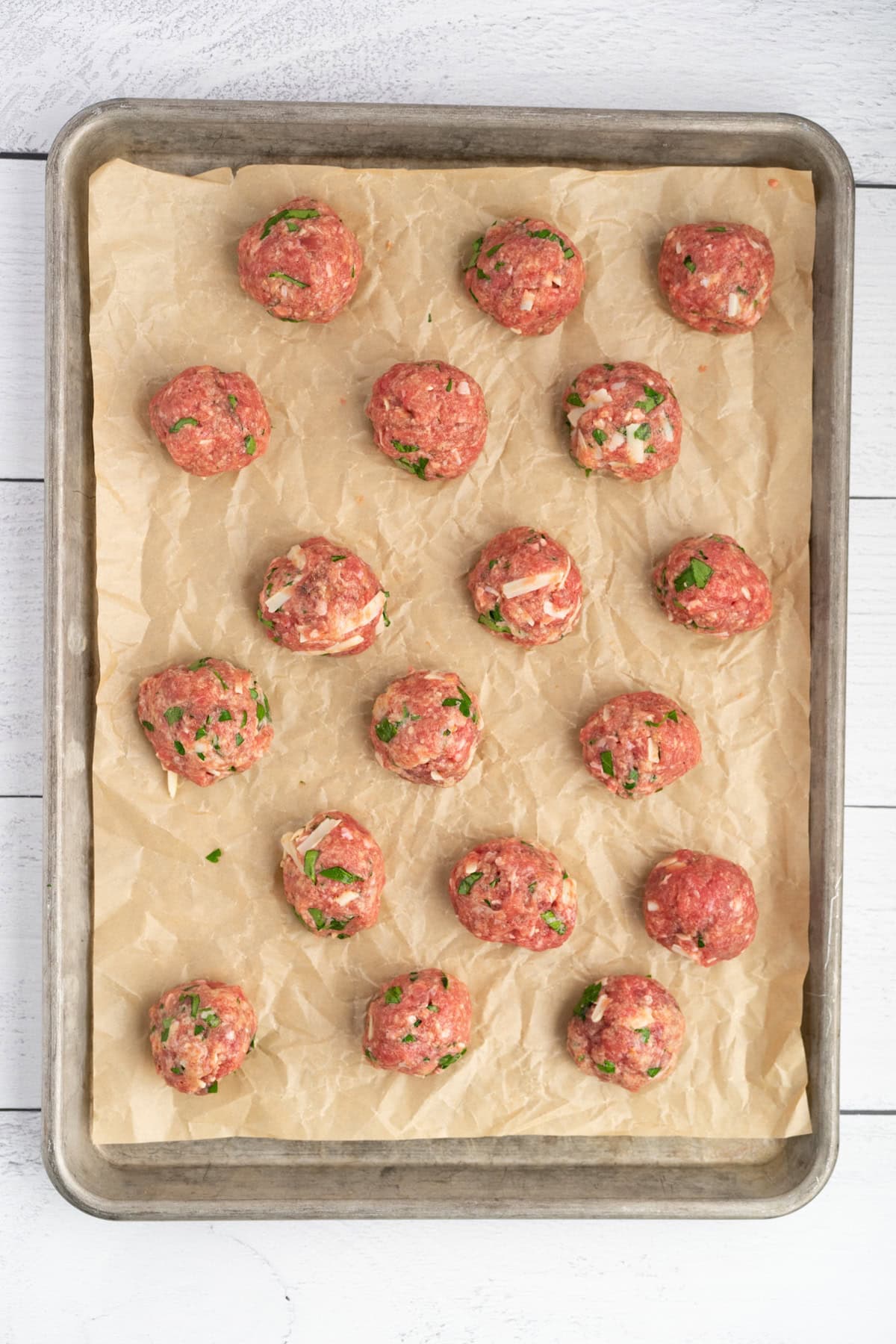 use a scoop to make 18 golf ball sized meatballs and place them on a baking sheet lined with parchment paper