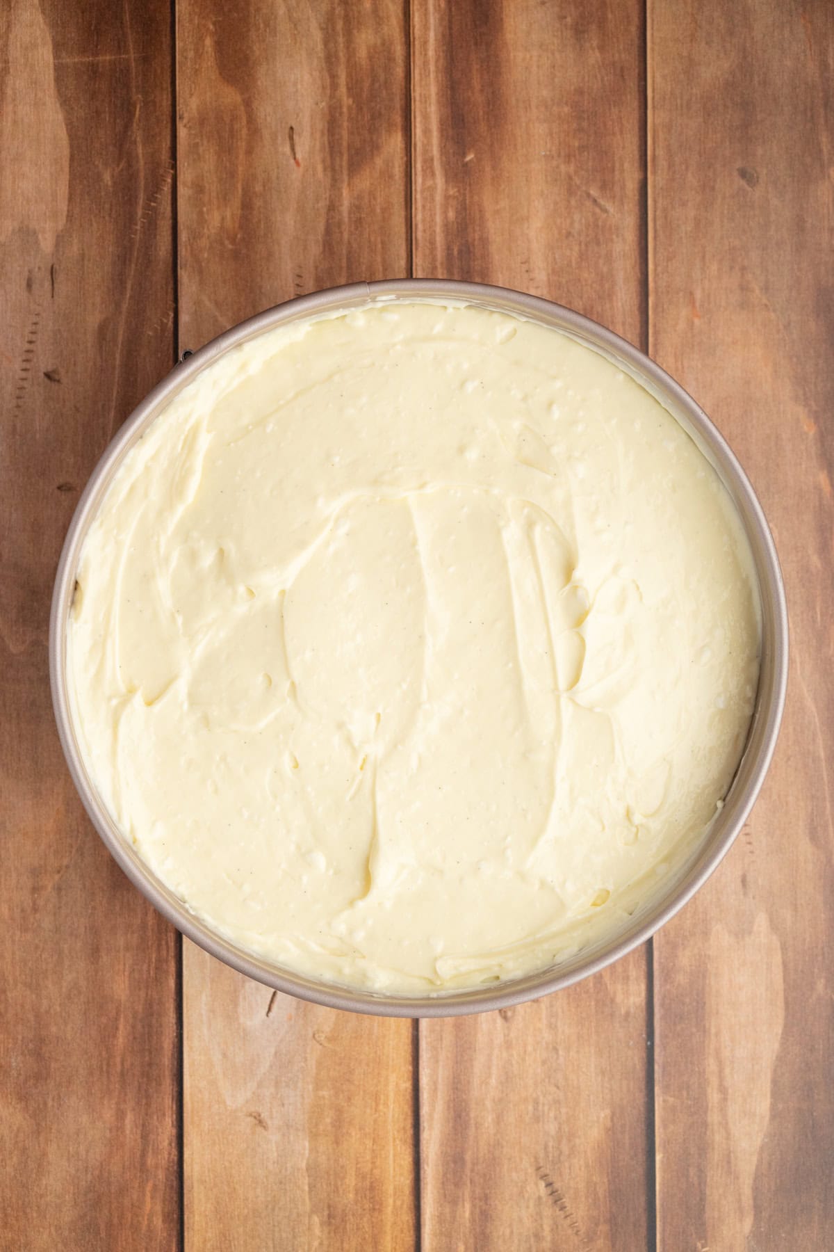 spread the cheesecake filling over the crust in the springform pan