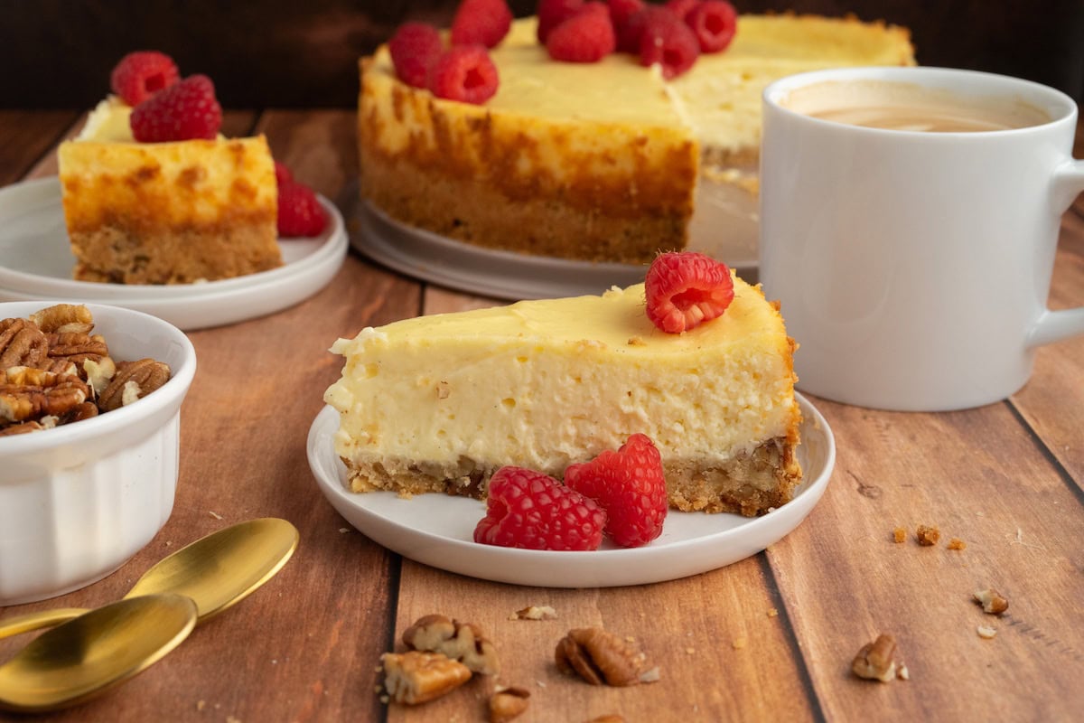 one slice of Gluten-Free Pecan Crust Cheesecake on a white plate